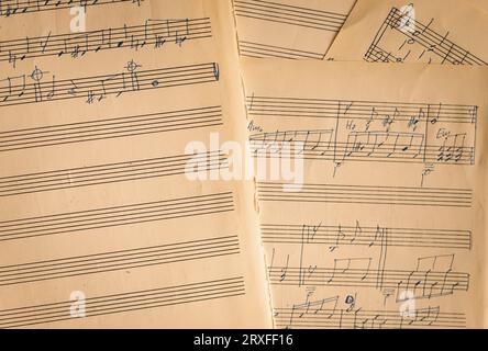 Notizen auf Papier. Altes Notenblatt. Melodie auf Seite. Notizen und Zeilen. Musikkonzept. Rhythmus auf Vintage-Rohling. Tonsymbole und -Schilder. Schlüssel und Notizen. Stockfoto
