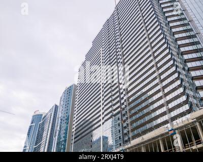 Batumi, Georgia. 09.24.2023 Bau eines Betonhauses. Moderne Gebäude. Gerüst. Industrieller Hintergrund. Verglasung eines Hochhauses Stockfoto
