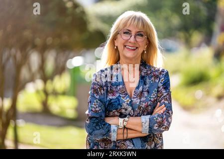 Porträt einer glücklichen Seniorin mit Brille, die draußen steht Stockfoto