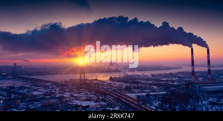 Sonnenaufgangsverschmutzung: Fabrikschornsteine, Die Treibhausgase Ausstoßen Stockfoto