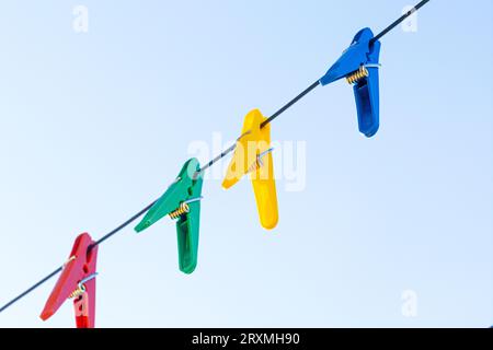 Bunte Clothespins auf den Kleiderbügeln. Plastische Clothespins in verschiedenen Farben. Mit Kopierraum Stockfoto