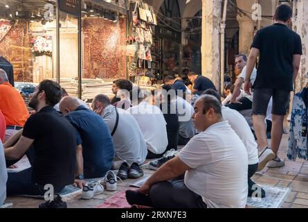 Muslimische Männer sitzen zum Mittagsgebet auf dem Großen Basar in Istanbul Türkei Stockfoto