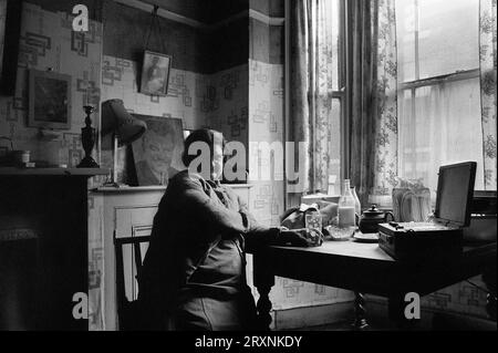 Ältere Dame saß im vorderen Raum ihres viktorianischen Hauses, das auf den Abriss während der Räumung des Slums von St Ann's, Nottingham, England, wartet. Stockfoto