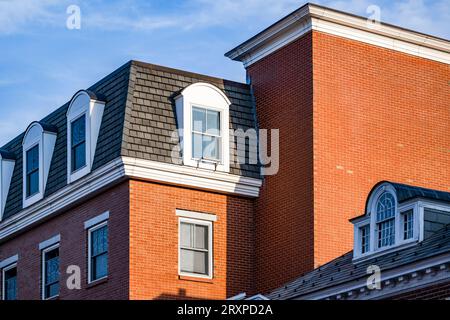 Ein klassisches, altes, mehrstöckiges, rotes Backsteingebäude in geometrischer Form mit Wohnzimmern auf dem Dachboden in Cambridge City Limit i Stockfoto