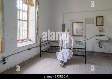 Eine Demo-Dummy in Child's Scooter im verlassenen Trans Allegheny Lunatic Asylum in Weston, West Virginia Stockfoto