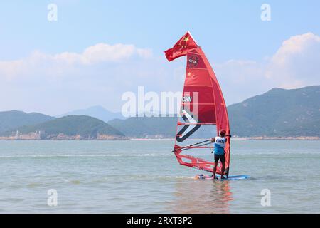 NINGBO, 27. September 2023 (Xinhua) -- BI Kun aus China feiert nach dem Sieg des Men's Windsurfing iQFoil Final of Sailing bei den 19. Asienspielen in Ningbo, ostchinesische Provinz Zhejiang, 27. September 2023. (Xinhua/Zhang Tao) Stockfoto