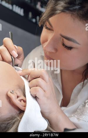 Der Prozess der Kleben knstliche Wimpern auf dem Auge des Modells, Makro  Stockfotografie - Alamy