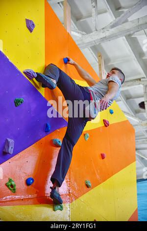 Free Climber man klettert an der Color Practice Wall. Extreme und gesundes Lifestyle-Konzept. Stockfoto