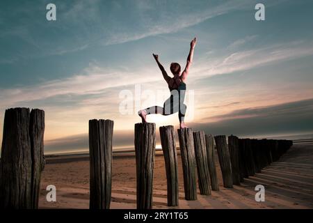 Sportliche Frau, Die Yoga Am Meer Macht Stockfoto