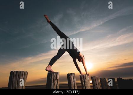 Sportliche Frau, Die Yoga Am Meer Macht Stockfoto