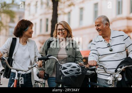 Glückliche Seniorenfreunde mit Fahrrädern auf dem Fußweg Stockfoto