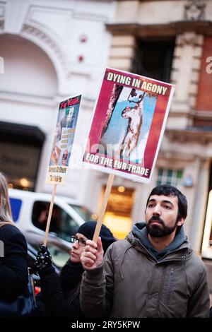 Tierschutzproteste vor Harvey Nichols London 30. November 2013 - junger Mann, der das Protestzeichen hochhält Stockfoto