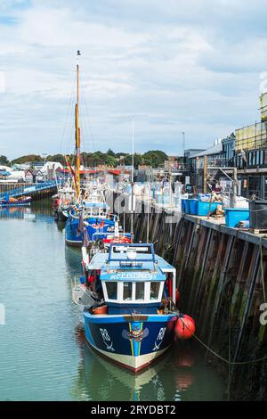 Whitstable, Großbritannien - 12. September 2023 farbenfrohe Fischerboote und Touristenboote im Hafen von Whitstable bei Ebbe. Stockfoto