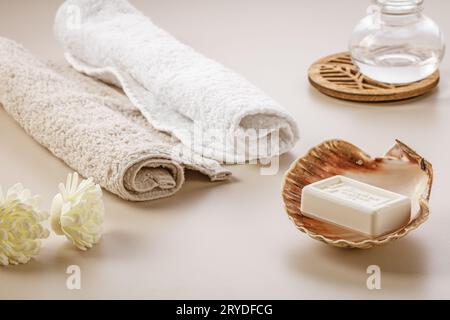 Minimalistischer skandinavischer Stil. Zwei weiche Handtücher, getrocknete Blumen und ein Stück Seife in einer Muschel auf dem Frisiertisch. Stockfoto