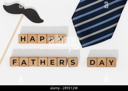 Blöcke zum Happy Vathers Day mit Krawatte auf weißem Hintergrund Stockfoto