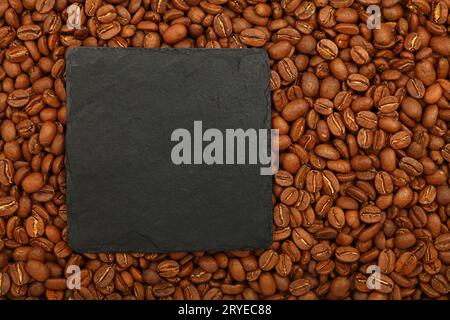 Schwarzes Schieferschild über gerösteten Kaffeebohnen Stockfoto