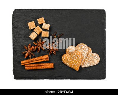 Herzförmige Lebkuchenkekse auf schwarzem Schiefer Stockfoto