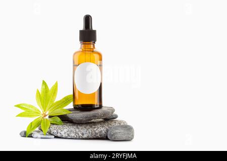 Pflanzliches ätherisches Öl auf Bernsteinflasche mit leerem Etikett isoliert auf weißem Hintergrund. Vorlage Mock up. Speicherplatz kopieren Stockfoto