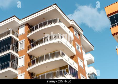 Balkone und blauer Himmel mit Wolken. Teil eines Wohngebäudes in der Türkei. Moderne Apartmenthäuser an einem sonnigen Tag. Stockfoto