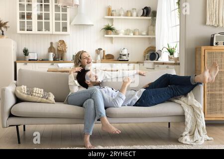 Wunderschönes, liebevolles Ehepaar, das sich auf der Couch ausruhen kann Stockfoto