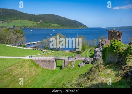 Urquhart Castle Drohne gedreht mit touristischen Spaziergängen rund um den Loch Ness See im Hintergrund, Schottland Stockfoto