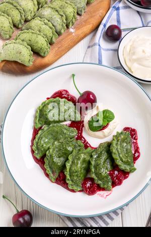 Hausgemachte Kirschknödel (Pierogien) mit Kirschsauce. Stockfoto