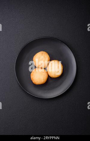 Köstliche frische süße Käsepfannkuchen mit Rosinen und Zimt auf einem Keramikteller Stockfoto