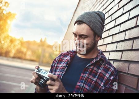 Sagen Cheese, Hipster Mode Fotograf Mann hält Retro-Kamera Stockfoto