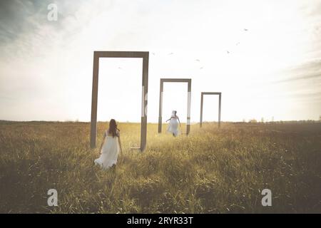 Frau stellt sich vor, wie sie durch surreale Türen läuft, in einem Feld, abstrakten Konzept Stockfoto