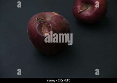 Verrottete Äpfel auf schwarzem Hintergrund, dunkle Sicht Stockfoto