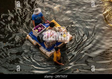 Über dem Kopf von thailändischen Flüchtlingen auf einem provisorischen Floß, das durch gefährliche Überschwemmungen in Rangsit, einem nördlichen Vorort von Bangkok, Thailand, fährt. © Kraig Lieb Stockfoto