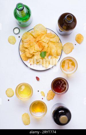 Verschiedene helle und dunkle Biere und Chips Stockfoto