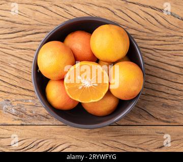 Cravo oder RosenZitronen in einer Schüssel über einem Holztisch. Stockfoto