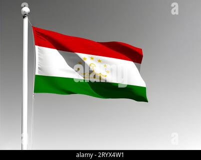 Tadschikistans Nationalflagge isoliert winkt auf grauem Hintergrund Stockfoto