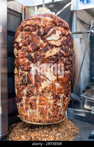 Gegrilltes Hühnchenfleisch auf einer vertikalen Rotisserie verwendet in traditionellem türkischen Street Food Döner Kebab, verbranntes ungesundes Fleisch Konzept. Hochwertige Fotos Stockfoto