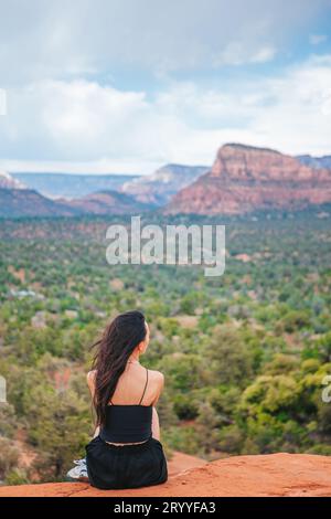 Frau genießt den Blick auf die Landschaft von Sedona von der Spitze des Bell Rock Wanderweges, der für seine vielen Energie-Wirbel und berühmt ist Stockfoto