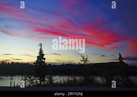 Farbenfroher Sonnenuntergang am Yukon River, Carmacks, Sommer, Yukon Territory, Kanada Stockfoto