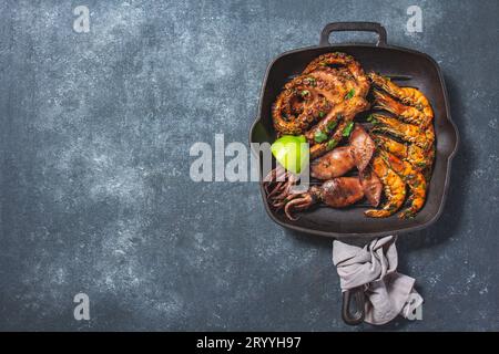 Gegrillte Zuhälter, Tintenfische und Kraken in einer gusseisernen Grillpfanne Stockfoto