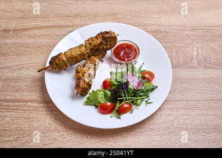 Zarte Hähnchenspieße, serviert mit frischem Salat und Dippsoße. Stockfoto