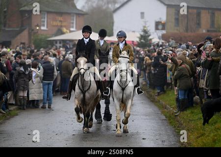 Essex mit Farmern und Union Hunt Hunderte von Menschen nehmen Teil, als sich das Essex mit Farmern und Union Hunt zu seiner jährlichen Fahrt am zweiten Weihnachtsfeiertag vom Chequers Pub im ländlichen Essex-Dorf Matching Green UK aufmacht. Die Essex Hunt trifft sich seit dem frühen 19. Jahrhundert regelmäßig in Matching Green, obwohl es seit dem Jagdgesetz von 2004 nicht erlaubt ist, Hunde zum Jagen und Töten von Füchsen zu verwenden. Matching Green Essex UK Copyright: XMartinxDaltonx Essex Hunt261224 MD 213 Stockfoto