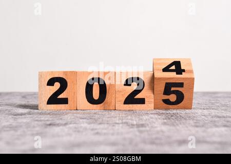 2025 Happy New Year. Holzwürfelblock Wechsel von 2024 auf 2025. Konzept 2025 Hintergrund zum Neujahr. Geschäft, Lösungen, Ziele, Inspiration, Erfolg, Stockfoto