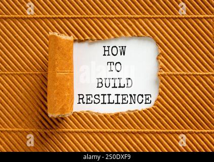 So erstellen Sie ein Resilienzsymbol. Konzeptworte wie man Resilienz auf einem schönen Whitepaper aufbauen kann. Schöner brauner Hintergrund. Unternehmen und wie man baut Stockfoto