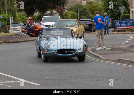 Jaguar E-Type fährt um einen Kreisverkehr Stockfoto