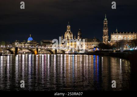 Dresden, deutsche Altstadt am Abend. Beleuchtete Gebäude an der Elbe. Wunderschöne Stadtlandschaft mit Sehenswürdigkeiten wie der Frauenkirche. Stockfoto