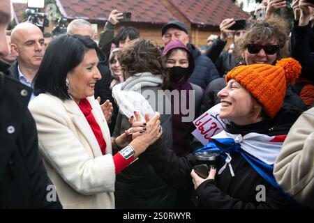 Der ehemalige Präsident Salome Zourabichvili begrüßt einen Unterstützer vor ihrem Wohnsitz in Tiflis, nachdem der neu gewählte, nicht aus dem Volk stammende Präsident Michail Kavelaschwili eingeweiht wurde, dessen Legitimität von Zurabichvili und Oppositionsparteien angefochten wird. Der ehemalige Präsident rief die Parlamentswahlen am 28. Oktober und die anschließende Wahl eines neuen Präsidenten, des ehemaligen Fußballspielers Michail Kavelaschwili, als unrechtmäßig und verfassungswidrig an, da die Regierungspartei diese Macht nicht ausüben kann, während sie wegen Vorwürfen von Wahlmanipulationen untersucht wird. Heute war Kavelaschwili Inau Stockfoto