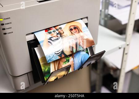 Moderner Drucker mit farbenfrohen Fotos im Innenbereich, Nahaufnahme Stockfoto