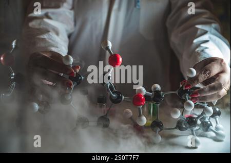 Rauchige Experimente am Molekularmodell. Wissenschaftler arbeiten an chemischen Reaktionen und erzeugen dicken Rauch. Kopierraum Stockfoto