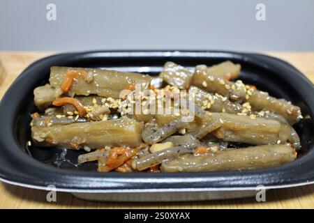 Klettenkinpira (gebratenes und gekochtes Wurzelgemüse), die in einem Supermarkt in Tokio, Japan, gekauft wurde Stockfoto