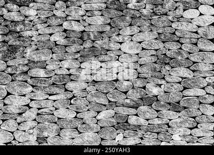 Hintergrundtextur der grauen Steinwand Schwarzweißfoto Stockfoto