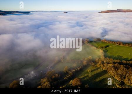 Drohnenaufnahme von tief liegendem Nebel, der ländliche Ackerflächen und Felder bedeckt (Brecon Beacons) Stockfoto